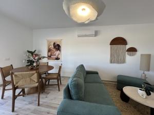 a living room with a couch and a table at 5th Element Espartal by Lisbeyond in Aljezur