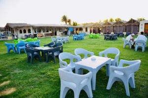 a group of tables and chairs in the grass at ايركرافت للسياحه العلاجيه Aircraft for Medical Tourism And Investment 