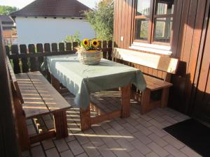 a table and two benches on a patio at Gästehaus Meier Ferienwohnung und Camping in Eschlkam