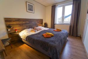 a bedroom with a bed with towels on it at Bed & Breakfast Hotel Het Gerendal in Valkenburg +14 photos
