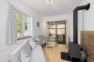 a living room with a couch and a wood stove at Baráček in Janov nad Nisou