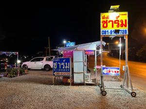 a gas station with signs on the side of a road at Charmtalamok Khaokho Resort in Ban Khao Ya Nua