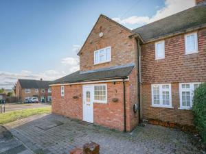 a brick house with a white door at Pass the Keys Stylish Modern 3 bed house with Parking in Rickmansworth