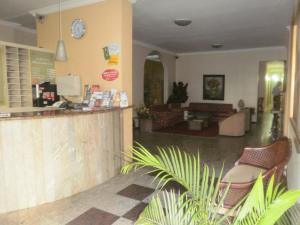 a lobby of a restaurant with a counter and chairs at Aldeota Praia Hotel in Fortaleza