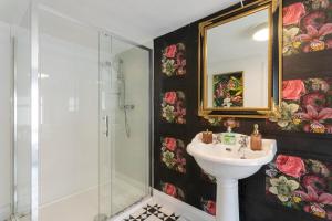 a bathroom with a sink and a shower and a mirror at Killorglin Irish Pub With Hot Tub That Sleeps 19 in Killorglin