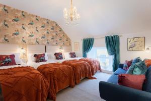 a bedroom with two beds and a chandelier at Killorglin Irish Pub With Hot Tub That Sleeps 19 in Killorglin
