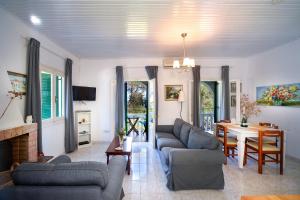 a living room with two couches and a table at Villa Maria in Kagkátika