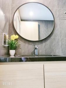 a bathroom with a sink and a mirror on the wall at YLY HOUSE in Ha Long