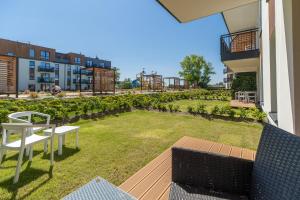 a small backyard with a playground in a building at Perfect Holiday Apartments Bel Mare by Renters in Międzyzdroje