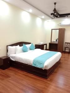 A bed or beds in a room at Athirappilly Inn