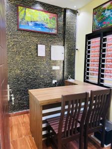 a dining room with a wooden table and two chairs at Athirappilly Inn in Athirappilly