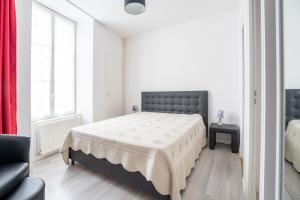 מיטה או מיטות בחדר ב-Coeur de Ville 1 & 2