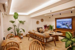 a living room with a couch and a tv at VillaQua Boutique Hotel in Şile