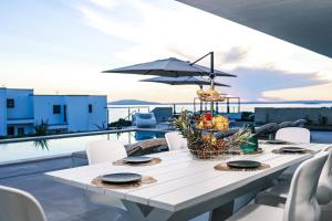 a white table with a basket of fruit on a balcony at Luxury Villa 360 - private heated pool in Novalja