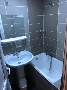 a bathroom with a sink and a toilet and a tub at YILDIZ HOTEL in Altındağ