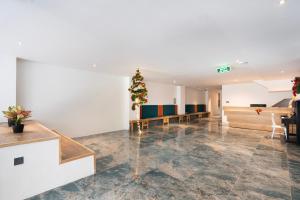 an empty lobby with a christmas tree on the wall at Haven Hut Riverside Hotel in Ho Chi Minh City