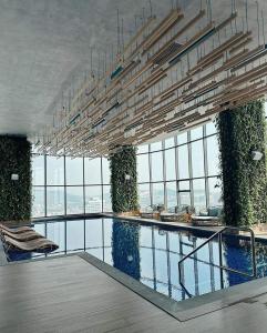 a large building with a swimming pool with windows at YLY HOUSE in Ha Long