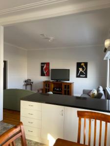 uma sala de estar com um sofá e uma televisão em Apartment 1 on Oxide em Broken Hill