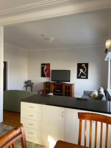 a living room with a couch and a tv at Apartment 1 on Oxide in Broken Hill