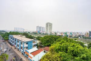 an overhead view of a city with buildings and trees at Haven Hut Riverside Hotel in Ho Chi Minh City