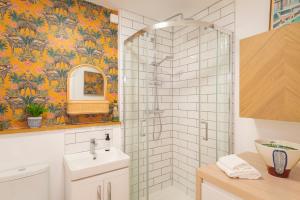 a bathroom with a shower and a sink at Idyllic Clifton Hideaway - Stunning Garden Flat in Bristol