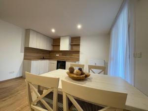a kitchen and dining room with a table and chairs at Apartmány Kľak in Kľačno