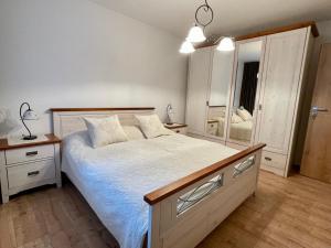 a bedroom with a bed and a large mirror at Apartmány Kľak in Kľačno