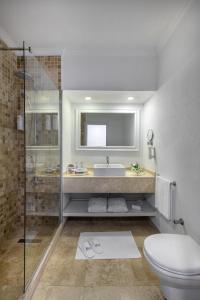 a bathroom with a toilet and a sink and a shower at Holiday Inn Resort Bodrum, an IHG Hotel- Ultra All Inclusive in Bodrum City