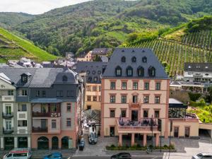 a group of buildings in a town with vineyards at DEINHARD's in Bernkastel-Kues