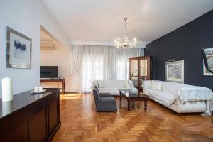 a large living room with a couch and a table at SERAFINA HOME in Thessaloniki