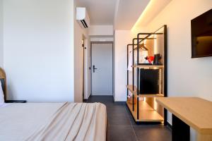una camera con letto, scrivania e specchio di Skia, Premium Key Collection a Città di Skiathos