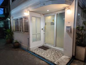 an entrance to a building with a white door at Green Apple Hostel Khaosan in Bangkok