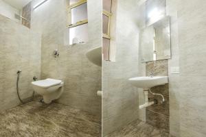 bagno con servizi igienici, lavandino e specchio di FabHotel Grand Royal Palms a Benaulim