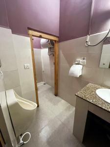 a bathroom with a toilet and a sink at Norbu Healing Hotel in Thimphu