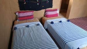 Letto o letti in una camera di Mhamid yaya camp & activités