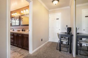 a kitchen with a sink and a table and a mirror at Bellanca in Discovery Bay