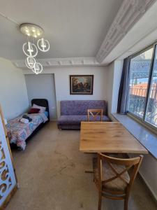 a living room with a table and a couch at Diamond Luxury Apartment - Haifa in Haifa