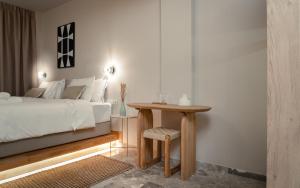 a bedroom with a bed and a table and a bed at Num Suites & Lofts Athens in Athens