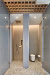 a bathroom with a shower with a toilet in it at Voyage Torba Hotel in Torba