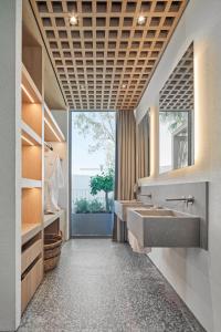 a bathroom with a sink and a large window at Voyage Torba Hotel in Torba