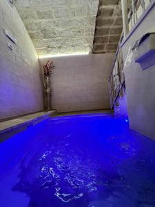 a swimming pool with blue water in a tunnel at Handy Specus in Brindisi