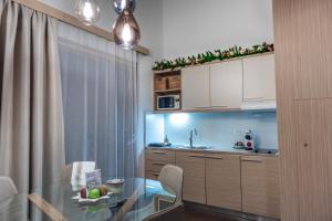 a kitchen with a glass table and a dining room at Apartment Rosemary in Topolšica
