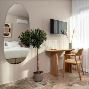 a room with a mirror and a table and a bed at Num Suites & Lofts Athens in Athens