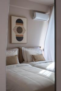 two beds sitting next to each other in a bedroom at Num Suites & Lofts Athens in Athens