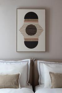 a picture above a bed in a hotel room at Num Suites & Lofts Athens in Athens