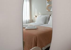a bedroom with a bed with two towels on it at Num Suites & Lofts Athens in Athens