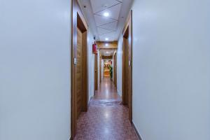 a corridor in a building with a long hallway at FabExpress Silver Inn in Ahmedabad