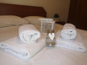 two towels on a bed with a heart on it at Makis Nest Apart-Hotel in Vourvourou +210 photos
