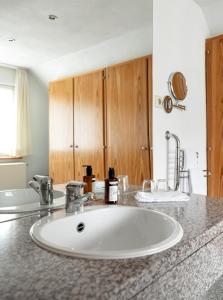 a bathroom with a sink and a counter top at Hotel am Mühlbach in Forbach