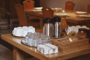 a wooden table with glasses and bottles on it at Rooms and Apartments Panker in Moravske-Toplice